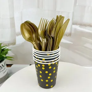 Disposable gold plastic cutlery set with polka dot paper cups for birthday party table decor