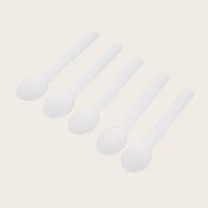 Detailed view of white disposable biodegradable spoons, clean design for party tableware.