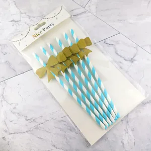 Blue and white striped paper straws with gold bow decorations for birthday party cake decor.