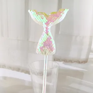 Sequin mermaid tail paper straw cake topper, colorful party decoration accessory detail.
