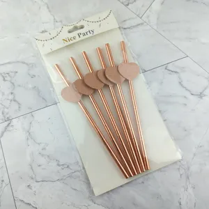 Rose gold paper drinking straws with glitter heart decorations for party and drink use.