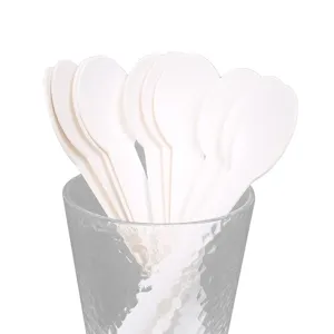 Eco-friendly disposable white paper spoons for party tableware and birthday event supplies.