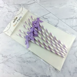Disposable striped paper straws with purple bows, perfect for party cake decoration and events.