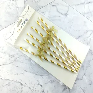 Gold and white striped paper straws with sparkly bow tie decorations for party cake decor details.