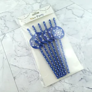 Detail view of Christmas paper drinking straws with blue snowflake toppers, festive party decor.