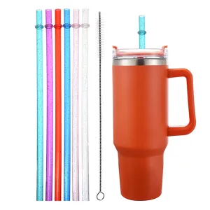 Detailed view of the insulated travel tumbler with reusable glitter straws and cleaning brush.