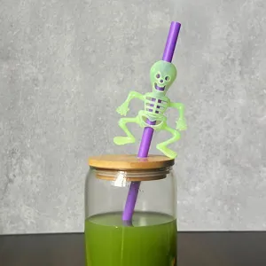 Halloween glowing green skeleton ghost straw detail close-up view for party drink decoration.
