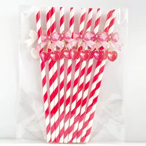 Red white striped paper straws with cute pink bow and cherry details for party decor.