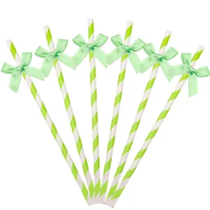 Green striped paper straws detail view with cute bowknot for birthday party table decor.