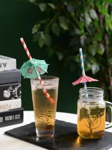 Disposable colorful paper drinking straws with cute cocktail umbrellas for party drinks and bars.