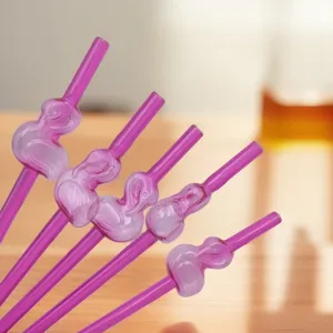 Close-up detail of pink flamingo shaped reusable art drinking straws for party events.