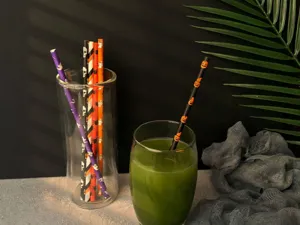 Halloween paper straws with spooky pumpkin and skull patterns for festive party decorations.