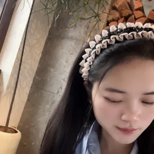 Detailed shot of a vintage pleated rhinestone hair hoop with ruffled edge for sweet styling.