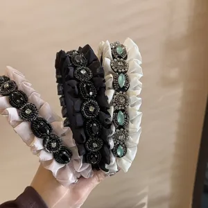 Detailed close-up of Korean style ruffled rhinestone headband with delicate pleats.