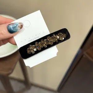 Élégante pince à cheveux en velours noir avec strass scintillants. Accessoire rétro parfait.