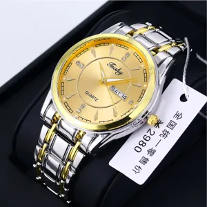 Men's quartz watch with gold dial, dual calendar display, and stylish two-tone strap.