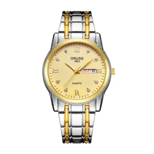Close-up of gold textured dial, Roman numerals, crystal hour markers and two-tone steel band.