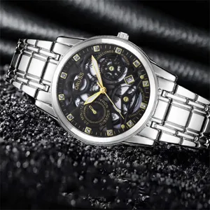 Men's silver metal wristwatch featuring black skeleton dial, crystal markers and date display.