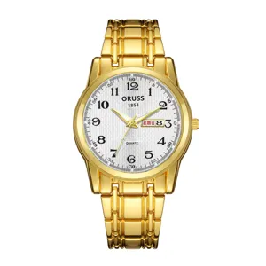 Gold quartz watch dial detail, textured white face with Arabic numerals and calendar.