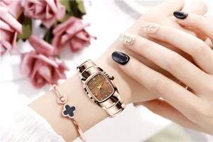 Close-up detail of women quartz watch with square brown dial and rose gold steel strap.