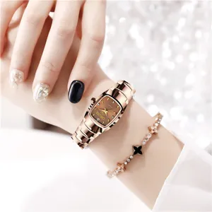 Close-up detail of women quartz watch with brown dial and rose gold steel strap on hand.