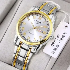 Detail view of a two-tone quartz watch with Roman numerals, calendar display and metal strap.