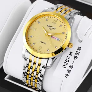 Detailed close-up of men's quartz watch with two-tone gold and silver bracelet and dial.