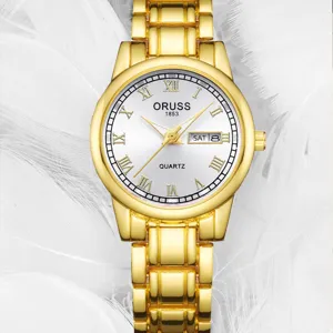 Élégante montre quartz dorée pour femme avec cadran blanc, chiffres romains et double calendrier.