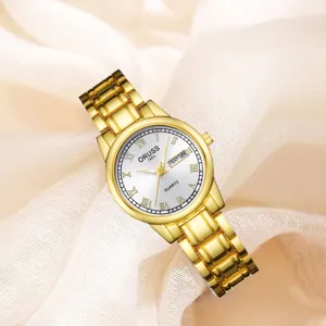Montre quartz pour femme dorée avec bracelet en métal, chiffres romains et calendrier.