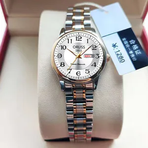Elegant women's watch with white dial, calendar display, and two-tone metal strap.