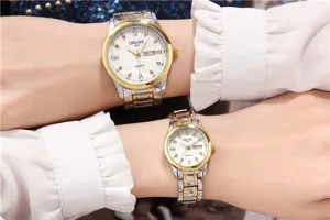 Detail shot of couple quartz watch, two-tone steel strap, white dial with rhinestone markers.