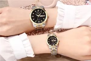 Detailed closeup of couple quartz watches featuring two-tone gold and silver steel straps.