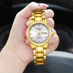 Montre quartz dorée pour femme avec chiffres romains, bracelet en métal et affichage du calendrier.