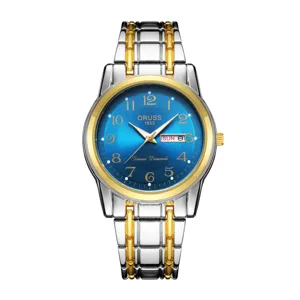 Close-up detail of the luxury men's two-tone metal watch with blue dial and date display.