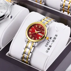 Women's quartz watch with red dial, gold bezel, Roman numerals, and two-tone steel strap.