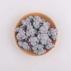 Perles éléphant en silicone gris avec noud rose pour attaches tétines et loisirs créatifs.