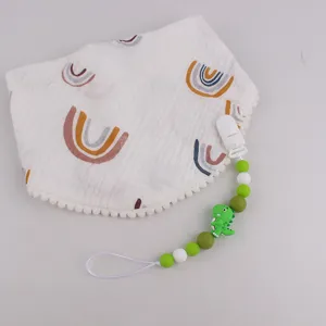 Cute baby bib with rainbow print and silicone dinosaur pacifier clip anti-drop chain set