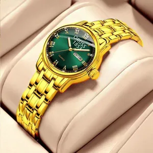 Women's vintage gold chain watch with green dial, elegant quartz timepiece detail view.