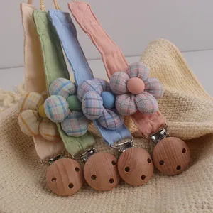 Handmade floral baby pacifier clip fabric dummy chain toy strap detail view for newborn infant.