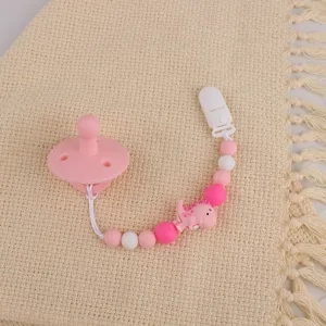 Silicone pacifier and beaded anti-drop clip chain set with cute dinosaur design for baby daily use.