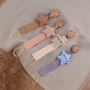 Cute star fabric baby pacifier clip detail showing multi-color teething toy straps securely.