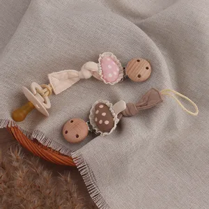 Cute handmade forest style mushroom baby pacifier clip set with wooden clasp for infant teeth care.