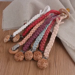 Handmade braided baby pacifier clip with floral wooden clip, colorful cotton strap for babies.