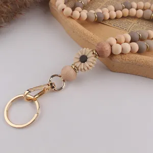 Holz und Silikon Perlen Lanyard Schlüsselanhänger Detail mit süßem Gänseblümchen und Metallring.