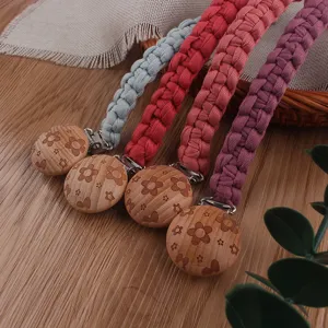 Handmade braided baby pacifier clips with colorful cotton and floral beech wood clips.