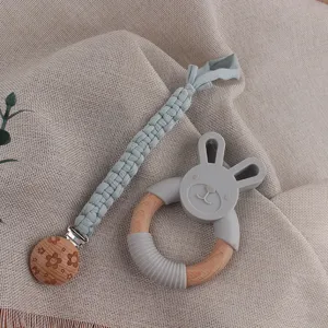 Woven baby pacifier clip and wooden silicone teether toy set, cute rabbit design safe for infants.