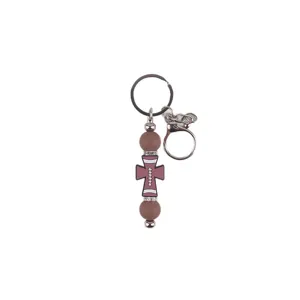 Porte-clés perlé croix en silicone avec mousqueton et anneau strass pour sacs et clés.