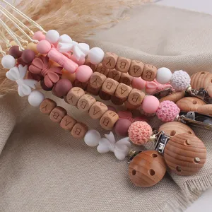 Silicone wooden baby pacifier clip detail, handmade teether toy chain for infants and toddlers.