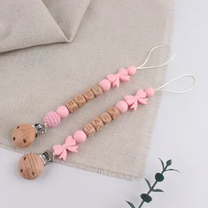 Cute silicone wooden baby pacifier chain clip teether toy anti-drop strap pink design.