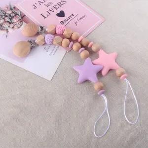 Cute wooden and silicone baby pacifier clip set with star pendant for safe soothing use.